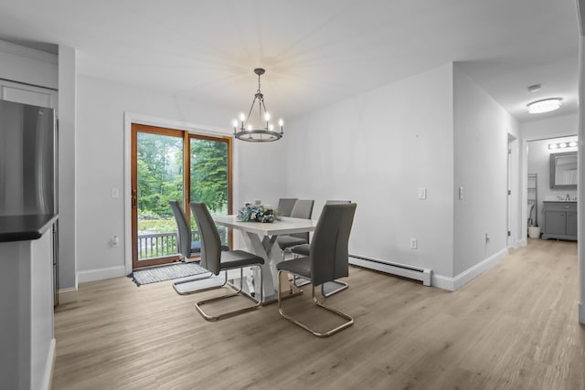 282 Back Narrows Rd, Boothbay, ME 04537 - dining space with baseboard heating, light wood-style floors, and a chandelier