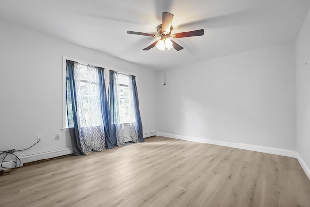 282 Back Narrows Rd, Boothbay, ME 04537 - empty room with light wood finished floors, ceiling fan, a baseboard radiator, and a baseboard heating unit
