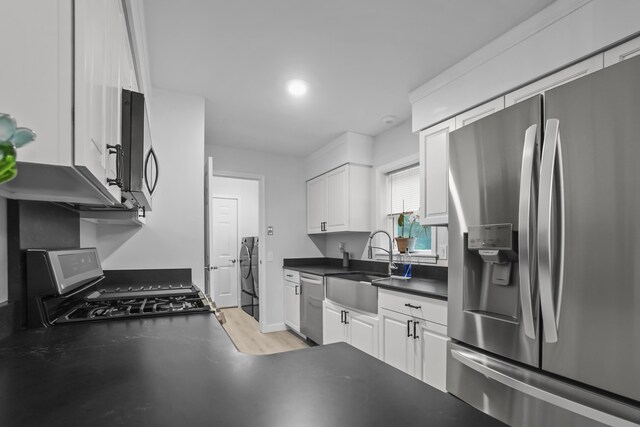 282 Back Narrows Rd, Boothbay, ME 04537 - kitchen featuring stainless steel appliances, white cabinets, and dark countertops