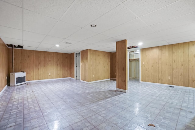 282 Back Narrows Rd, Boothbay, ME 04537 - finished basement featuring heating unit, a drop ceiling, and wooden walls