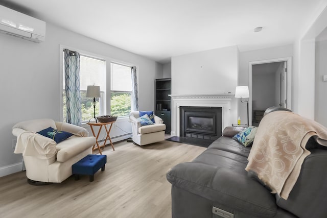282 Back Narrows Rd, Boothbay, ME 04537 - living area featuring a wall mounted air conditioner, a baseboard heating unit, light wood-type flooring, and a fireplace with flush hearth
