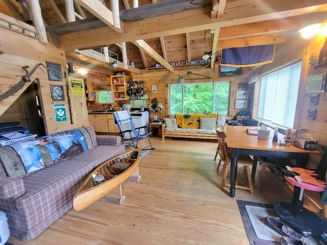 40 Griffin Mountain Rd, New Vineyard, ME 04956 - living area featuring wooden walls, light wood-style floors, high vaulted ceiling, and beam ceiling