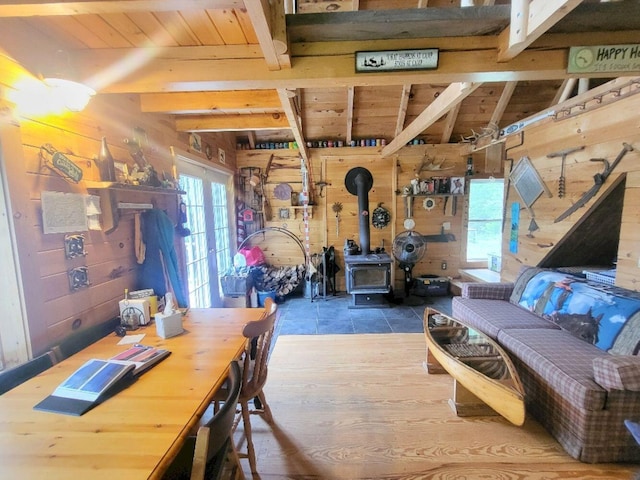 40 Griffin Mountain Rd, New Vineyard, ME 04956 - dining space with wood walls, a wooden ceiling with exposed beams, a wood stove, and tile patterned floors