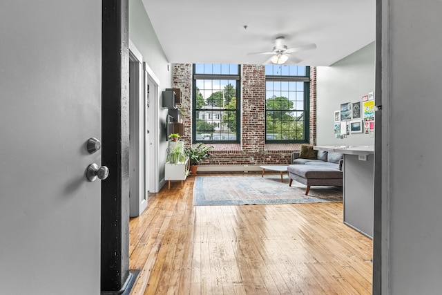 30 Lincoln St Unit 109, Westbrook, ME 04092 - foyer featuring light wood-style floors, a ceiling fan, and brick wall