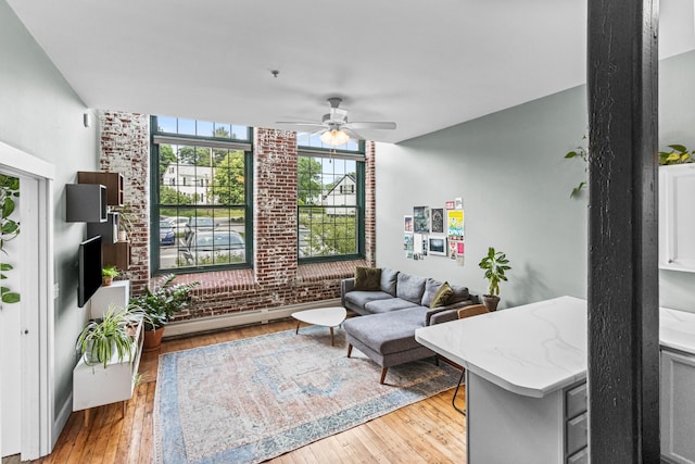 30 Lincoln St Unit 109, Westbrook, ME 04092 - living room with a ceiling fan, light wood-type flooring, and brick wall