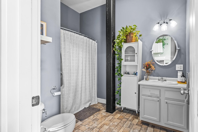 30 Lincoln St Unit 109, Westbrook, ME 04092 - full bathroom with vanity, toilet, brick patterned floors, curtained shower, and baseboards