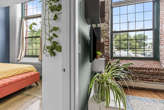 30 Lincoln St Unit 109, Westbrook, ME 04092 - bedroom featuring wood-type flooring, brick wall, and baseboard heating