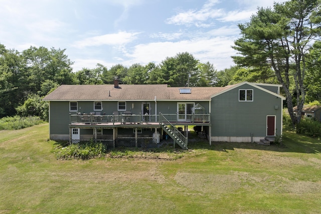 474 Center St, Nobleboro, ME 04555 - rear view of property featuring a deck, a lawn, view of wooded area, and a chimney