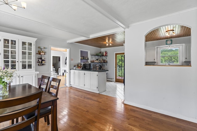 474 Center St, Nobleboro, ME 04555 - dining room featuring plenty of natural light, a chandelier, beam ceiling, light wood-style flooring, and arched walkways
