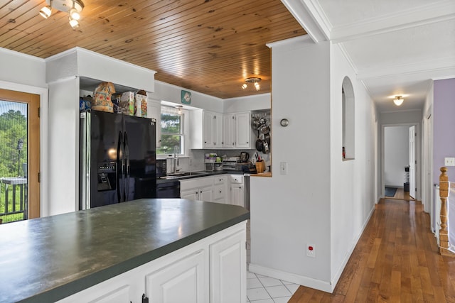 474 Center St, Nobleboro, ME 04555 - kitchen with black appliances, dark countertops, crown molding, white cabinetry, and arched walkways