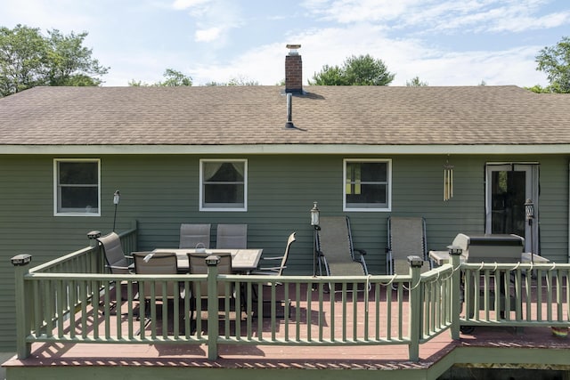 474 Center St, Nobleboro, ME 04555 - back of house featuring a chimney, roof with shingles, outdoor dining space, and a wooden deck