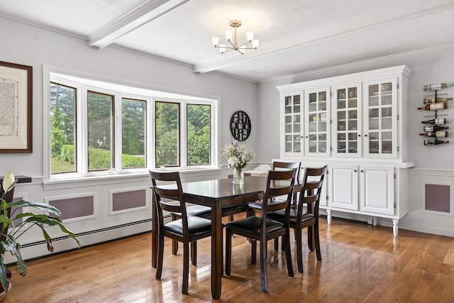 474 Center St, Nobleboro, ME 04555 - dining area with a chandelier, a baseboard heating unit, beamed ceiling, and hardwood / wood-style flooring