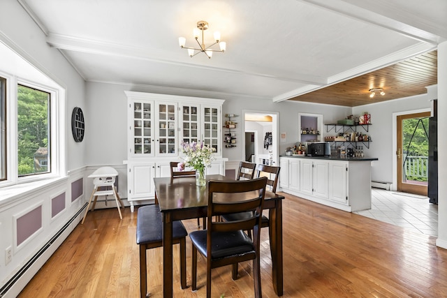 474 Center St, Nobleboro, ME 04555 - dining area featuring a baseboard heating unit, a chandelier, light wood finished floors, and beamed ceiling