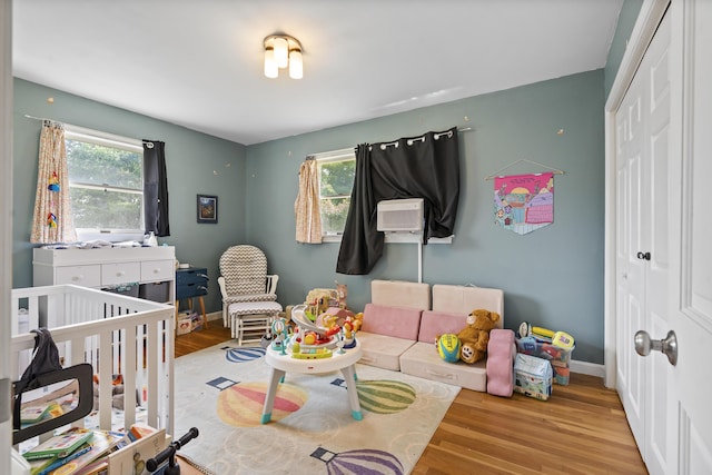 474 Center St, Nobleboro, ME 04555 - bedroom with a closet, wood finished floors, cooling unit, and a crib