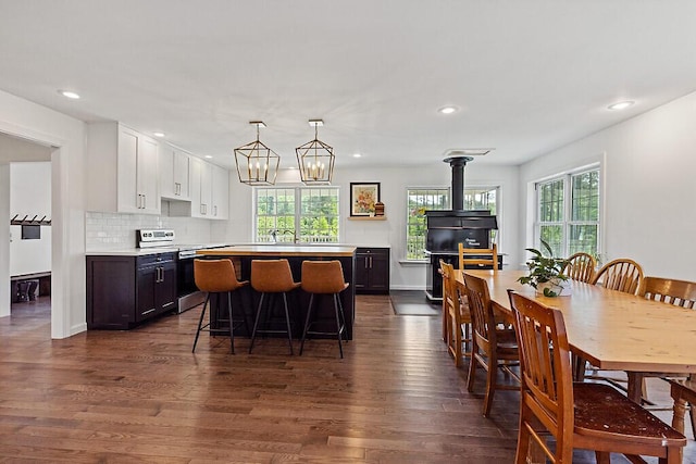 43 Brookside Ln, Freeman Twp, ME 04983 - kitchen featuring stainless steel electric stove, light countertops, dark wood-style flooring, a kitchen bar, and recessed lighting