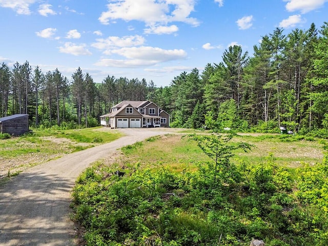 43 Brookside Ln, Freeman Twp, ME 04983 - view of front of home with a view of trees, dirt driveway, and a front lawn