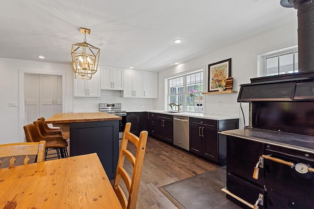 43 Brookside Ln, Freeman Twp, ME 04983 - kitchen featuring stainless steel appliances, wooden counters, white cabinetry, a chandelier, and dark wood finished floors