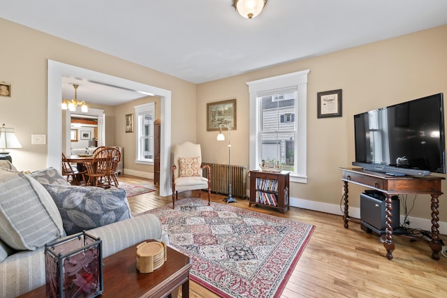 223 Centre St, Bath, ME 04530 - living room with radiator, wood-type flooring, and a chandelier