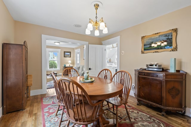 223 Centre St, Bath, ME 04530 - dining space featuring a chandelier and wood finished floors