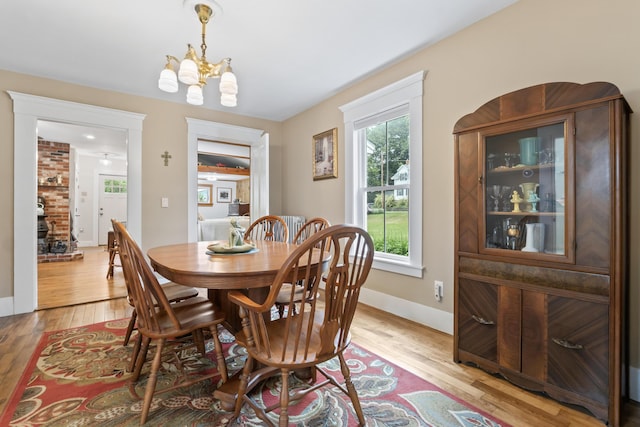 223 Centre St, Bath, ME 04530 - dining room with a chandelier and light wood-style floors