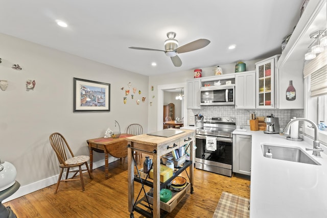223 Centre St, Bath, ME 04530 - kitchen featuring appliances with stainless steel finishes, a ceiling fan, light countertops, light wood-style floors, and recessed lighting