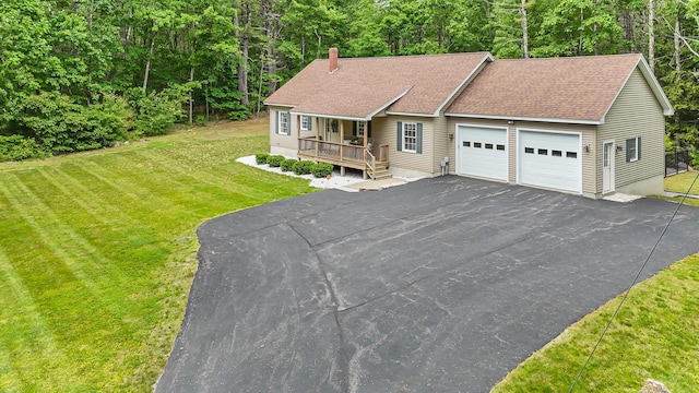 5 Willard Way, Raymond, ME 04071 - view of front of property with a garage, covered porch, a chimney, a front lawn, and asphalt driveway