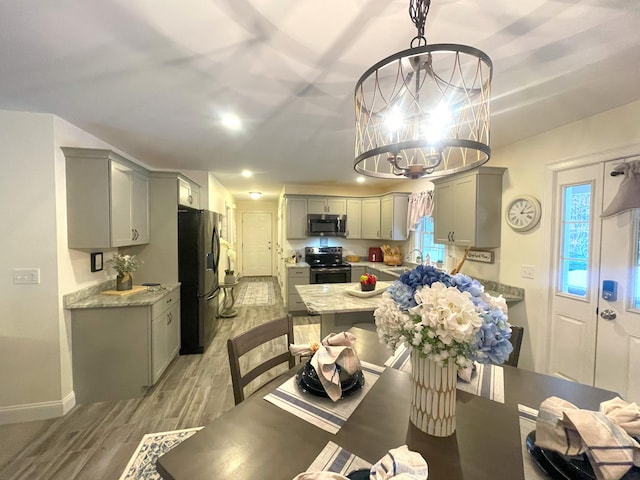 5 Willard Way, Raymond, ME 04071 - dining area with light wood-style flooring, a chandelier, and baseboards