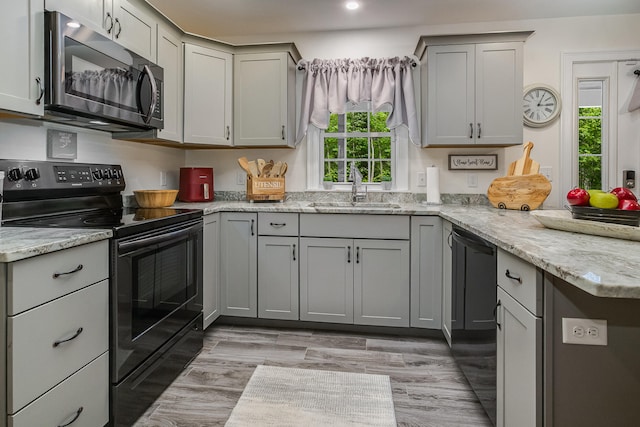 5 Willard Way, Raymond, ME 04071 - kitchen with black appliances, a sink, gray cabinets, light stone countertops, and a peninsula