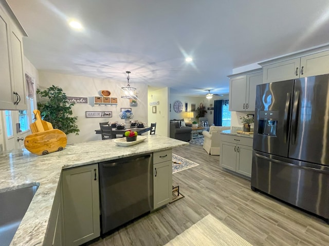 5 Willard Way, Raymond, ME 04071 - kitchen featuring appliances with stainless steel finishes, a peninsula, light wood-style floors, gray cabinetry, and recessed lighting