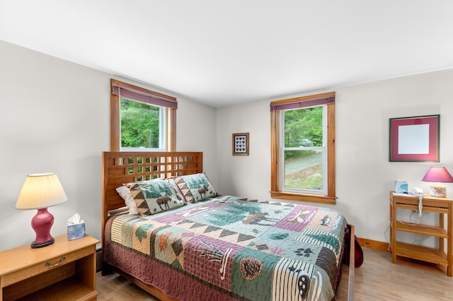 302 Spring St, Brownfield, ME 04010 - bedroom with light wood-style flooring and multiple windows
