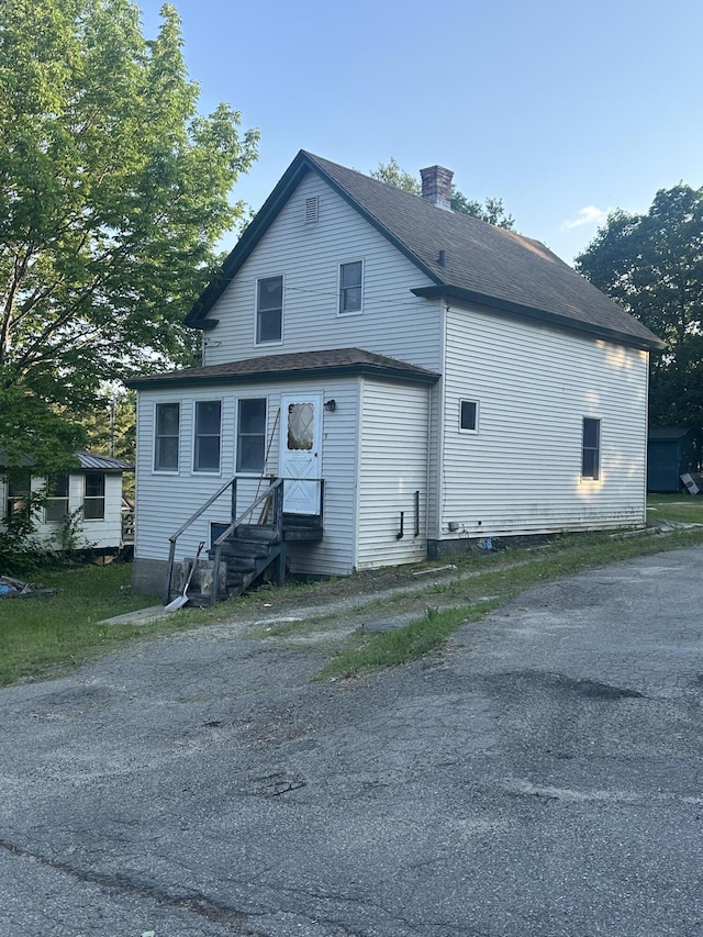 8 Lincoln St, Millinocket, ME 04462 - rear view of house with a chimney, a shingled roof, and entry steps