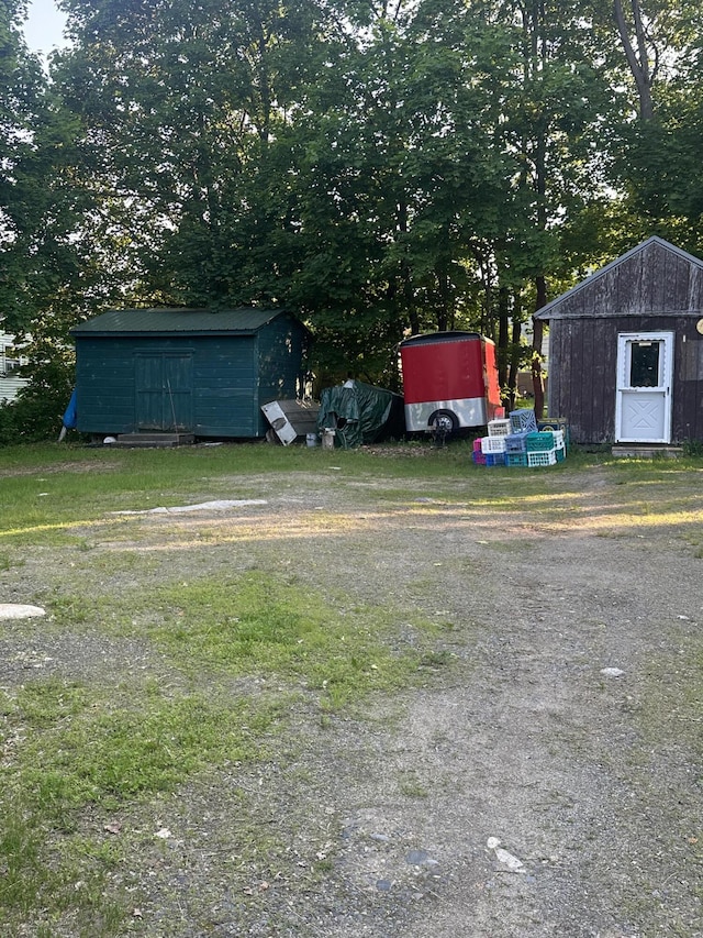 8 Lincoln St, Millinocket, ME 04462 - view of yard with a shed and view of wooded area