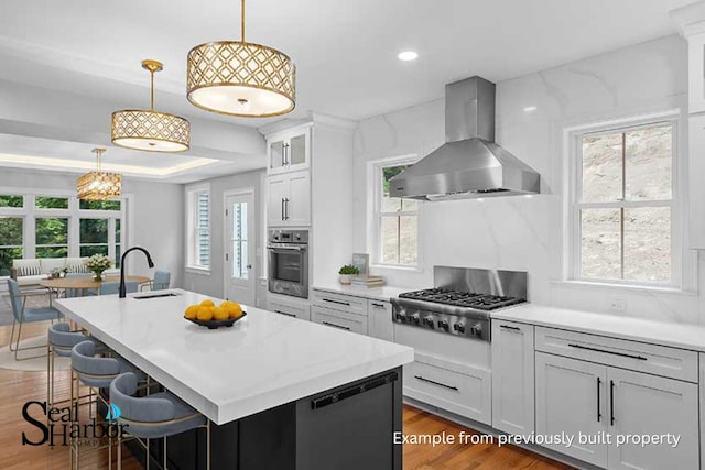 11 Clam Ln Unit B, Wells, ME 04090 - kitchen with wall chimney exhaust hood, stainless steel appliances, healthy amount of natural light, wood finished floors, and recessed lighting