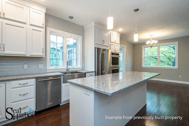 11 Clam Ln Unit B, Wells, ME 04090 - kitchen featuring appliances with stainless steel finishes, a chandelier, dark wood-style floors, a center island, and white cabinets