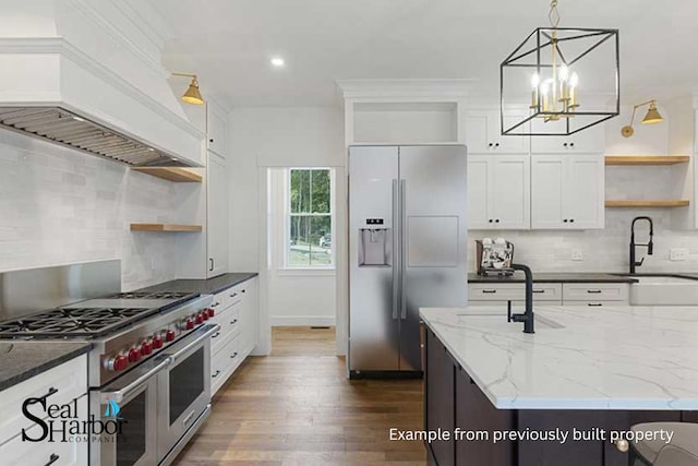 11 Clam Ln Unit B, Wells, ME 04090 - kitchen with open shelves, premium appliances, custom exhaust hood, dark wood finished floors, and decorative backsplash