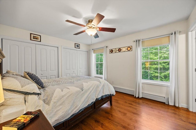 22 Fox Run Rd, Gray, ME 04039 - bedroom with two closets, a baseboard radiator, wood finished floors, ceiling fan, and baseboard heating