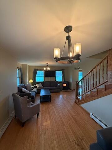 396 E Ridge Rd, Mars Hill, ME 04758 - living room featuring a chandelier, a baseboard radiator, wood finished floors, and stairs