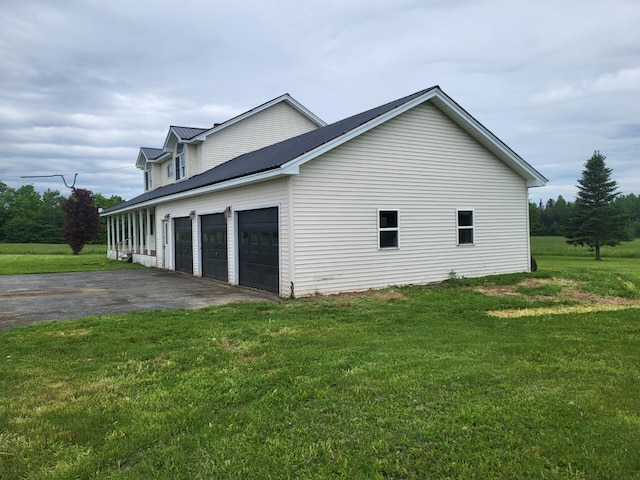 396 E Ridge Rd, Mars Hill, ME 04758 - view of side of home with driveway, a yard, and a metal roof