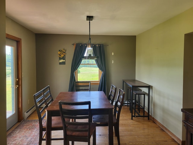 396 E Ridge Rd, Mars Hill, ME 04758 - dining room with healthy amount of natural light, light wood-style flooring, and a baseboard heating unit