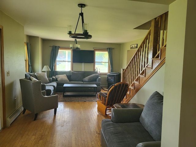 396 E Ridge Rd, Mars Hill, ME 04758 - living area with a baseboard heating unit, hardwood / wood-style flooring, stairs, and a chandelier