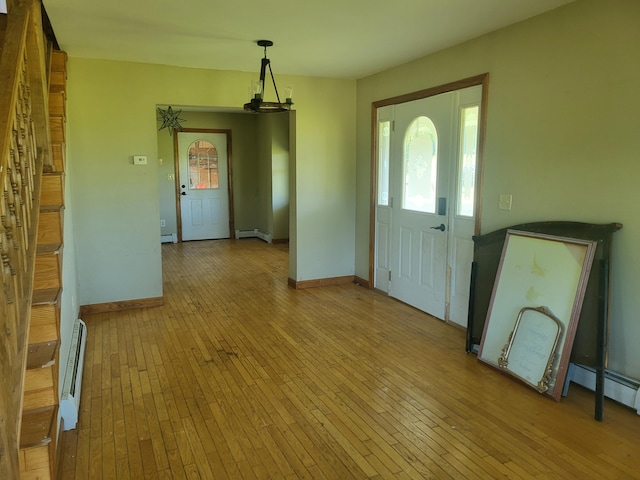 396 E Ridge Rd, Mars Hill, ME 04758 - foyer with baseboard heating, light wood finished floors, healthy amount of natural light, and a baseboard radiator