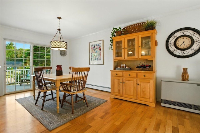 4 Hawthorne Pl, Lewiston, ME 04240 - dining area featuring crown molding, light wood-style flooring, and a baseboard heating unit