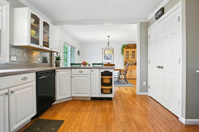 4 Hawthorne Pl, Lewiston, ME 04240 - kitchen with black dishwasher, light wood-style flooring, white cabinets, glass insert cabinets, and a peninsula