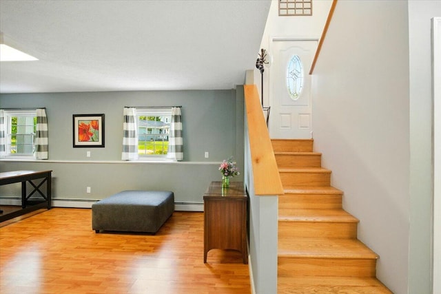 4 Hawthorne Pl, Lewiston, ME 04240 - staircase featuring a baseboard heating unit and wood finished floors