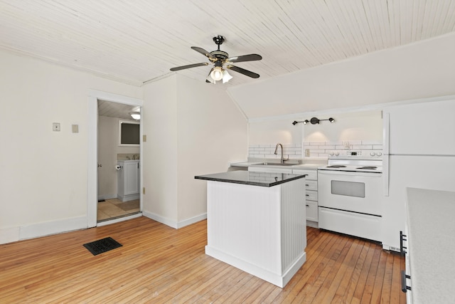 200 Main St, Freeport, ME 04032 - kitchen with white appliances, ceiling fan, light wood-type flooring, backsplash, and white cabinetry