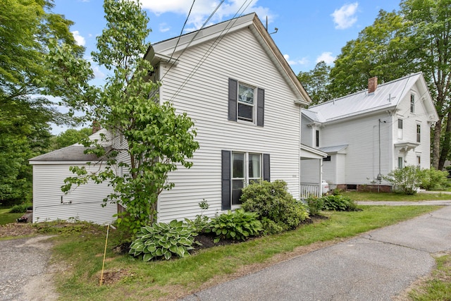 200 Main St, Freeport, ME 04032 - view of property exterior with a chimney and a metal roof