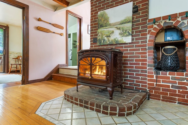 385 Sabbathday Rd, New Gloucester, ME 04260 - detailed view of wood finished floors and a wood stove