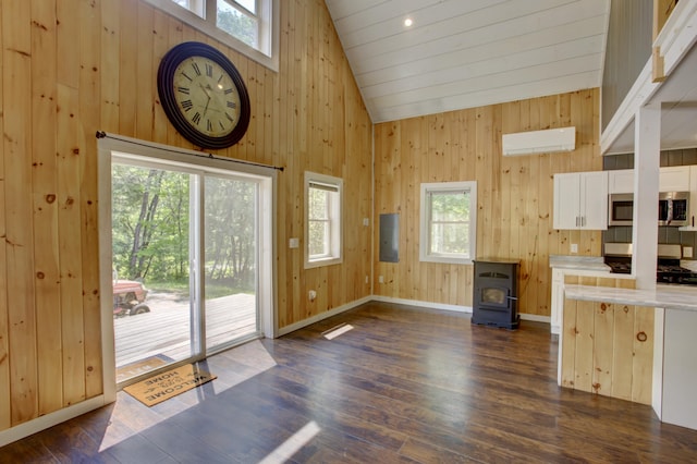 6 Meadow Ln, Sabattus, ME 04280 - doorway to outside featuring a wood stove, healthy amount of natural light, a wall mounted AC, high vaulted ceiling, and wooden walls