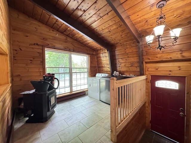 235 S Reynolds Rd, Winslow, ME 04901 - laundry area featuring washing machine and clothes dryer, a wood stove, a chandelier, wooden walls, and wooden ceiling