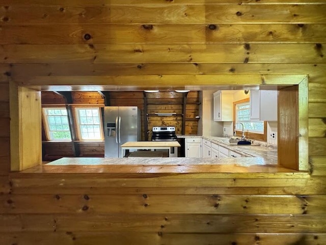 235 S Reynolds Rd, Winslow, ME 04901 - kitchen featuring appliances with stainless steel finishes, white cabinetry, and a peninsula